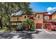 Charming condo with colorful accents, well-manicured landscaping, and attached garages at 2138 Chianti Pl # 142, Palm Harbor, FL 34683