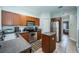 Efficient kitchen with stainless steel appliances, wood cabinets, and tile floors at 2138 Chianti Pl # 142, Palm Harbor, FL 34683