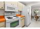 Bright kitchen featuring orange countertops and white appliances at 2338 Gainesborough Loop # 0, Sun City Center, FL 33573