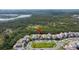 Aerial view of a neighborhood with manicured lawns, close to a lake and surrounded by Florida woods at 2630 Yellow Sundial Loop, Ruskin, FL 33570
