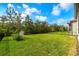 Expansive backyard with lush green grass and a black metal fence at 2630 Yellow Sundial Loop, Ruskin, FL 33570
