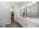 Elegant bathroom with double vanity, quartz countertops, and walk-in closet access at 2630 Yellow Sundial Loop, Ruskin, FL 33570