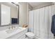 Clean bathroom features a vanity with modern faucet and a shower with a curtain at 2630 Yellow Sundial Loop, Ruskin, FL 33570