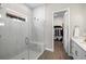 Modern bathroom featuring glass shower with bench and adjacent walk-in closet at 2630 Yellow Sundial Loop, Ruskin, FL 33570