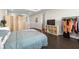 Spacious bedroom featuring a folding screen, tv, and clothes rack at 2630 Yellow Sundial Loop, Ruskin, FL 33570