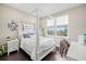 Cozy bedroom with a four-poster bed and ample natural light from the windows at 2630 Yellow Sundial Loop, Ruskin, FL 33570