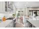 Modern white kitchen with stainless steel appliances and large island, perfect for entertaining and cooking at 2630 Yellow Sundial Loop, Ruskin, FL 33570