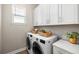 Laundry room equipped with appliances, ample storage, and stylish countertop at 2630 Yellow Sundial Loop, Ruskin, FL 33570