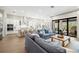 Open-concept living room with a large sectional sofa, view of the kitchen and outdoor space at 2630 Yellow Sundial Loop, Ruskin, FL 33570