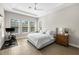 Spacious main bedroom with tray ceiling, exercise bike, and abundant natural light from large windows at 2630 Yellow Sundial Loop, Ruskin, FL 33570