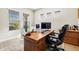 Well-lit office features a large desk and multiple windows at 2630 Yellow Sundial Loop, Ruskin, FL 33570