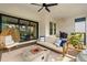Outdoor living area with modern seating, fire pit, and ceiling fan at 2630 Yellow Sundial Loop, Ruskin, FL 33570