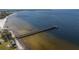 Aerial view of a serene pier, perfect for peaceful waterfront strolls and enjoying the coastal scenery at 2630 Yellow Sundial Loop, Ruskin, FL 33570