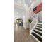 Elegant staircase with white railings, leading to the upper level and a glimpse of the living area at 2630 Yellow Sundial Loop, Ruskin, FL 33570