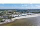 An elevated view of the Sunset Grill and Tiki Bar with a white sandy beach and blue skies at 2630 Yellow Sundial Loop, Ruskin, FL 33570