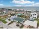 An aerial view showcases a vibrant coastal neighborhood, close to the beach and community at 2710 Hibiscus W Dr, Belleair Beach, FL 33786