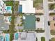 An aerial view of a residential neighborhood showcasing swimming pools, well maintained lawns and lush landscaping at 2710 Hibiscus W Dr, Belleair Beach, FL 33786