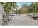 Large brick paved backyard with outdoor seating and palm tree landscaping at 2710 Hibiscus W Dr, Belleair Beach, FL 33786