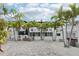 Spacious backyard featuring palm trees and outdoor seating area at 2710 Hibiscus W Dr, Belleair Beach, FL 33786