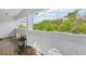 Charming balcony with a view of lush greenery at 2710 Hibiscus W Dr, Belleair Beach, FL 33786