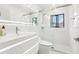 Bathroom with a glass-enclosed shower, modern fixtures, and sleek, bright vanity at 2710 Hibiscus W Dr, Belleair Beach, FL 33786