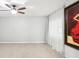 Bright room featuring neutral paint, modern door and large artwork at 2710 Hibiscus W Dr, Belleair Beach, FL 33786