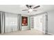 Airy bedroom featuring neutral paint, modern door and large artwork at 2710 Hibiscus W Dr, Belleair Beach, FL 33786