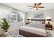 Bright bedroom with large window, ceiling fan and modern furnishing at 2710 Hibiscus W Dr, Belleair Beach, FL 33786