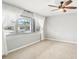 Serene bedroom with a large window, light wood floors and a ceiling fan at 2710 Hibiscus W Dr, Belleair Beach, FL 33786