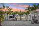 Beautiful home exterior showcasing a lovely patio and well-placed palm trees in front of the building at 2710 Hibiscus W Dr, Belleair Beach, FL 33786