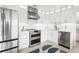 Stylish modern kitchen with stainless steel appliances and white cabinets at 2710 Hibiscus W Dr, Belleair Beach, FL 33786
