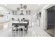 Bright kitchen with white cabinets, stainless steel hood, unique lighting and central island at 2710 Hibiscus W Dr, Belleair Beach, FL 33786