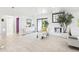 Open-concept living space with tile floors, fireplace, neutral color palette, and modern furnishings at 2710 Hibiscus W Dr, Belleair Beach, FL 33786