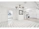 Open living space with white walls, tiled floors, a fireplace and views to other rooms at 2710 Hibiscus W Dr, Belleair Beach, FL 33786