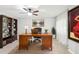 Office area with a ceiling fan, art, bookshelf and modern desk at 2710 Hibiscus W Dr, Belleair Beach, FL 33786