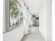 Enclosed patio with a wall of windows and a view of the palm trees at 2710 Hibiscus W Dr, Belleair Beach, FL 33786