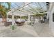 Outdoor living space with a white pergola and dining area for entertaining at 2710 Hibiscus W Dr, Belleair Beach, FL 33786