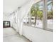 Sunroom area with natural light and palm tree view at 2710 Hibiscus W Dr, Belleair Beach, FL 33786
