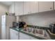 Kitchen with stainless steel sink, microwave, white cabinets and green countertops at 2808 W Azeele St # 201, Tampa, FL 33609