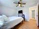 This bedroom features wood floors, ceiling fan and access to the Primary bathroom at 2904 Lichen Ln # A, Clearwater, FL 33760