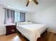 Bedroom with wood floors, a queen bed, neutral colored bedding, and a large window at 2904 Lichen Ln # A, Clearwater, FL 33760