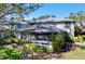 Well-maintained two-story exterior with a screened in porch and lush landscaping at 2904 Lichen Ln # A, Clearwater, FL 33760
