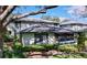 Charming two-story home with green trim, a screened in porch, and well-maintained landscaping at 2904 Lichen Ln # A, Clearwater, FL 33760