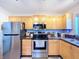 Modern kitchen featuring stainless steel appliances, granite countertops, and ample cabinetry at 2904 Lichen Ln # A, Clearwater, FL 33760