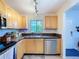 Well-lit kitchen with wooden cabinets, granite countertops, and stainless steel appliances at 2904 Lichen Ln # A, Clearwater, FL 33760