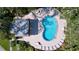 Aerial view of the community pool featuring trees, lounge chairs, and tables at 2904 Lichen Ln # A, Clearwater, FL 33760