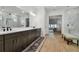 Modern bathroom with double vanity, glass shower, and view to the main bedroom at 29423 Toricelli Rd, Wesley Chapel, FL 33543