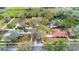 This aerial view showcases the neighborhood, featuring mature trees and lush landscaping at 3701 Barnhouse Pl, Valrico, FL 33596