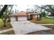 Beautiful home featuring a three-car garage, manicured landscaping, and a well-maintained exterior at 3701 Barnhouse Pl, Valrico, FL 33596