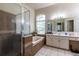 Bright bathroom with tiled shower, a soaking tub, vanity with sink and a large mirror at 3701 Barnhouse Pl, Valrico, FL 33596